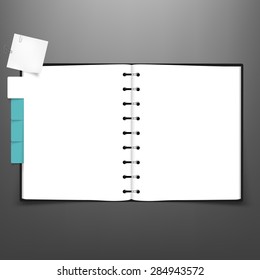 Open spiral notebook with white page and tabs.