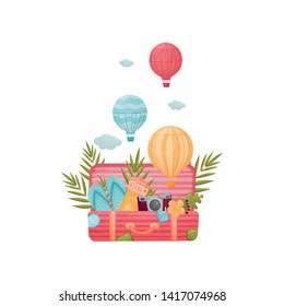 Open striped pink suitcase with attributes for traveling inside. Vector illustration on white background.
