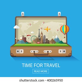 Open suitcase with famous landmarks on a blue background for travel and tourism. 