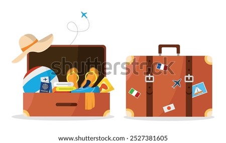 An open suitcase with travel stuff and a closed suitcase.
