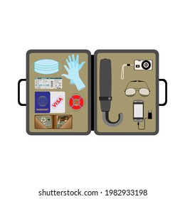 Open traveler's briefcase. Top view. Essential items. Medical mask, gloves. Transport ticket, passport, visa, insurance. Wallet, cash, credit cards. Umbrella, camera, sunglasses. Mobile phone, charger