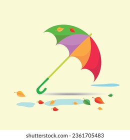 An open umbrella among puddles and leafy trees.