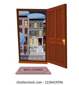 Open wood brown door into winter city starry night view with snowy trees, burning lantern. Door mat. Flat cartoon style vector illustration. Three-four-story uneven colorful houses. Street cityscape.