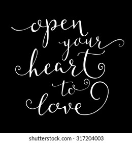 'Open your heart to love' calligraphy lettering sign on black background