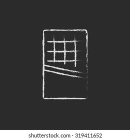 Opened bar of chocolate hand drawn in chalk on a blackboard vector white icon isolated on a black background.