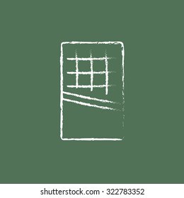 Opened bar of chocolate hand drawn in chalk on a blackboard vector white icon isolated on a green background.