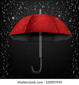 The opened red and black umbrella on falling rain and snow background