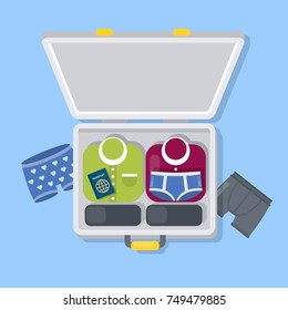 Opened traveling suitcase with male clothes, passport and underwear.