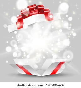 Opened white gift box with red bow and lights