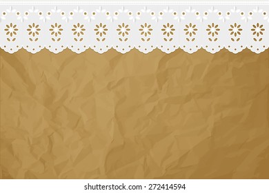 Openwork embroidery on crumpled paper brown background