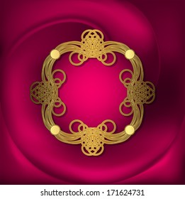 Openwork gold frame on pink fabric with folds