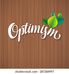 Optimism calligraphic poster. Hand Calligraphy card motivation template on wood background with shadow