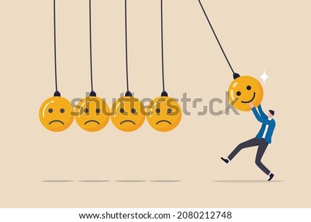 Optimistic, happiness or positive thinking inspire other people happy, emotional intelligence or balance between happiness and sadness, man holding smile face pendulum ball to hit other sad faces. 商業照片 © 