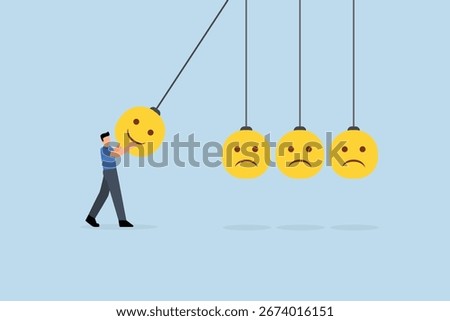 Optimistic, man holding a smiling face pendulum ball to strike other frowning faces 