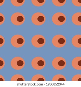 Orange abstract pattern in the form of circles on a blue background. Seamless background in the style of the 70s. For textiles, wallpapers and backgrounds.