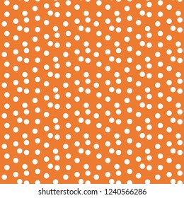 Orange background scattered dots polka seamless pattern . Vector illustration.