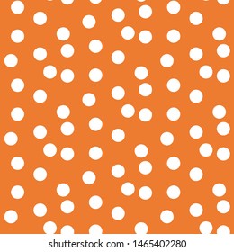 Orange background scattered dots polka seamless pattern . Vector illustration.