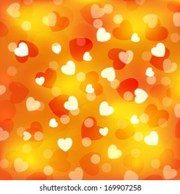 Orange bokeh background with small hearts 