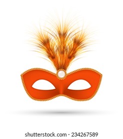 Orange carnival mask with fluffy feathers isolated on white background
