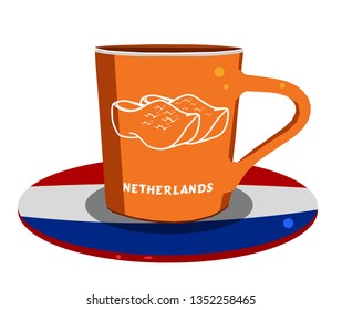 Orange color cup with netherlands flag and wooden shoes picture