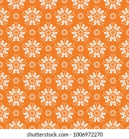 Orange floral ornament with white elements. Seamless pattern for textile and wallpapers