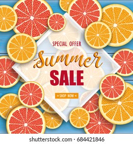 Orange and grapefruit fruits on the blue wooden background with frame and text Summer Sale.  Eps 10 vector file.