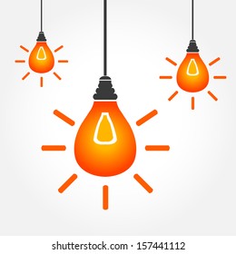 Orange hanging light bulbs on white background