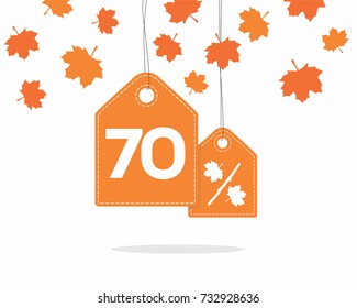 Orange hanging price tag labels with 70% and a maple leaf percent design texts on them and with shadow on white background with leaves. For autumn sale campaigns.