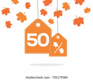 Orange hanging price tag labels with 50% and a maple leaf percent design texts on them and with shadow on white background with leaves. For autumn sale campaigns.