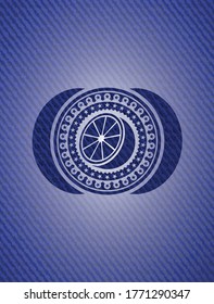 orange icon inside badge with denim texture. 