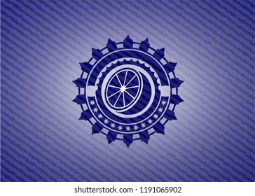 orange icon inside emblem with denim texture