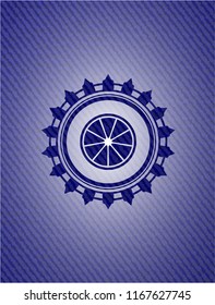 orange icon inside emblem with jean background