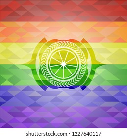 orange icon inside emblem on mosaic background with the colors of the LGBT flag