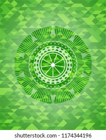 orange icon inside green emblem. Mosaic background