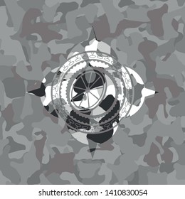 orange icon inside grey camo emblem