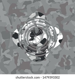 orange icon inside grey camo emblem