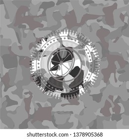 orange icon inside grey camouflaged emblem