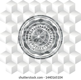 orange icon inside grey emblem with geometric cube white background