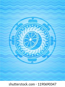 orange icon inside light blue water wave emblem background.