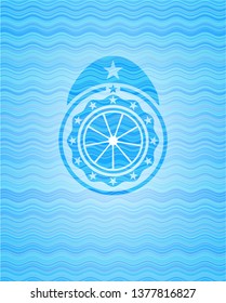 orange icon inside light blue water wave badge background.