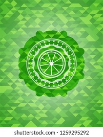 orange icon inside realistic green mosaic emblem
