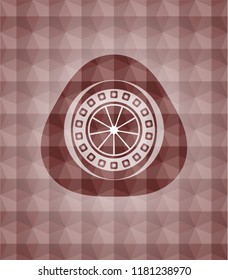 orange icon inside red seamless polygonal badge.