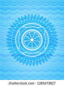 orange icon inside sky blue water wave style emblem.