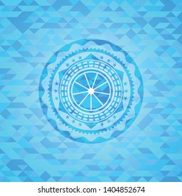 orange icon inside sky blue emblem with triangle mosaic background