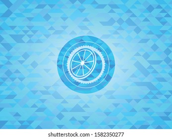 orange icon inside sky blue mosaic emblem