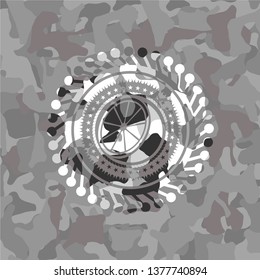 orange icon on grey camouflage pattern