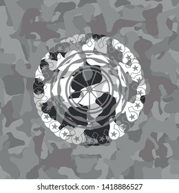 orange icon on grey camouflage pattern