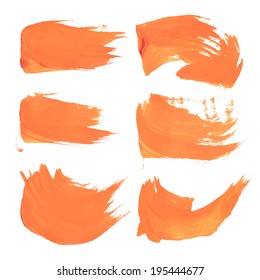 Orange liquid paint strokes on white 