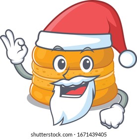 Orange macaron in Santa cartoon character design showing ok finger