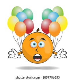 Orange mascot character holding a balloon. vector illustration